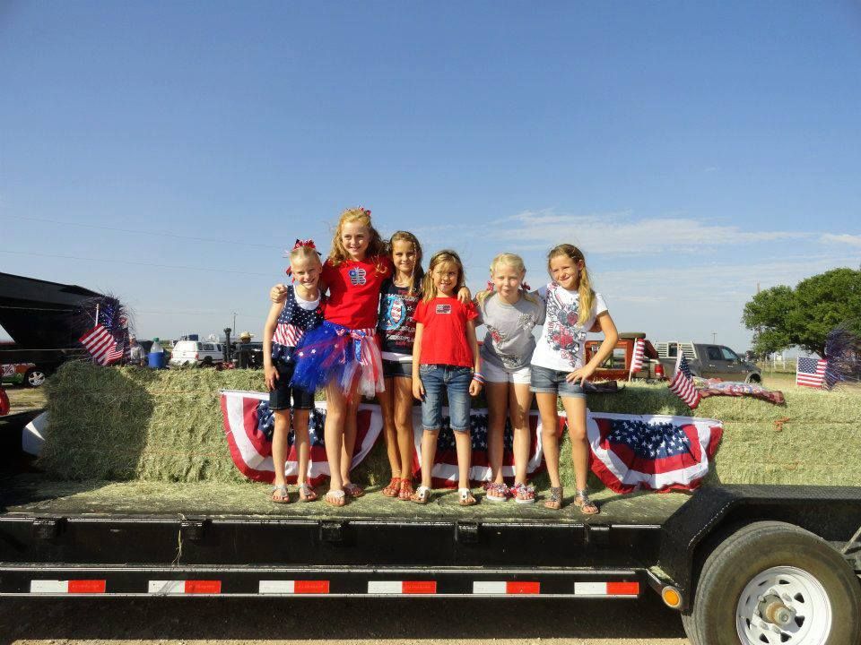 Girls in red, white and blue on a parade float