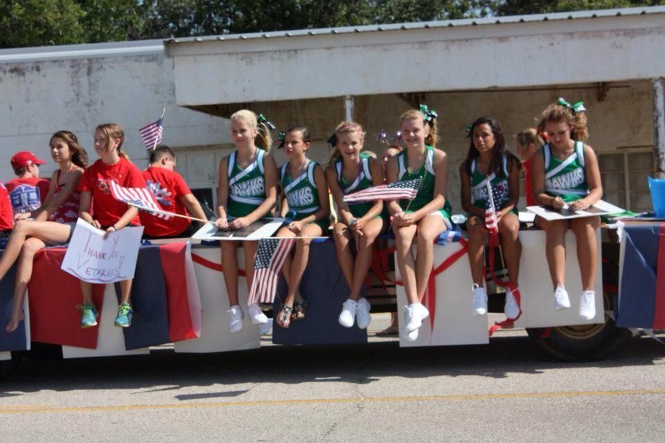 Cheerleaders riding a parade float