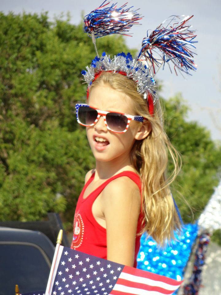 Girl in star sunglasses and a sparkly headband