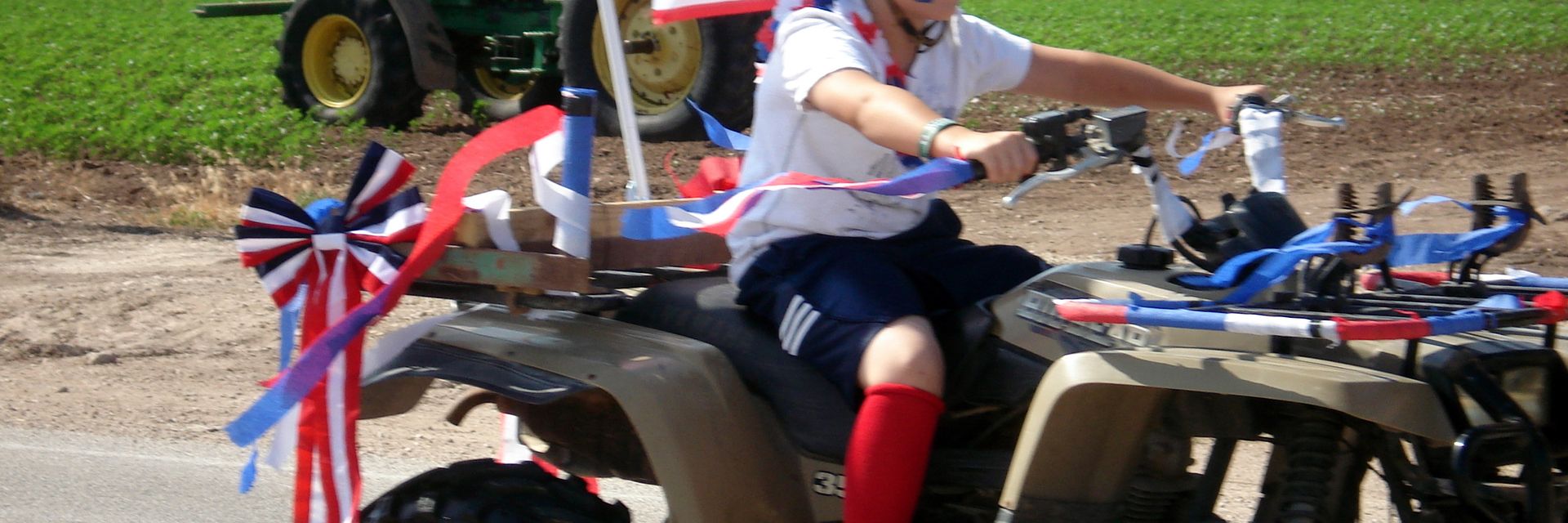 Young rider with a flag on a four-wheeler