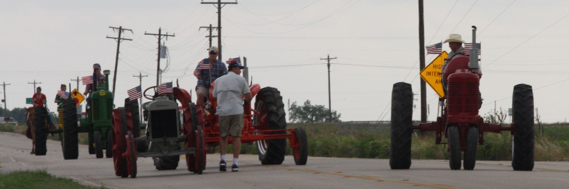 Antique tractors rolling down the parade route
