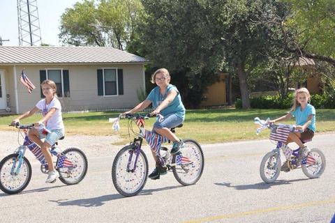 Kids riding decorated bicycles