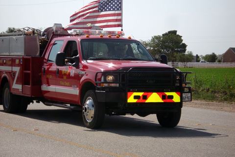 Fire truck flying an American flag in the parade
