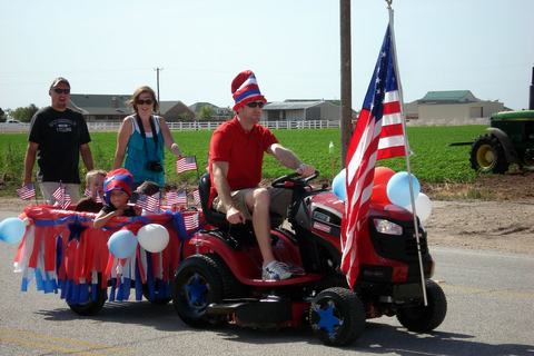 Riding mower pulling a mini float